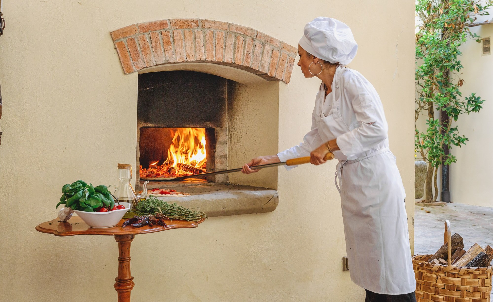 Pizza being placed into a wood fired oven